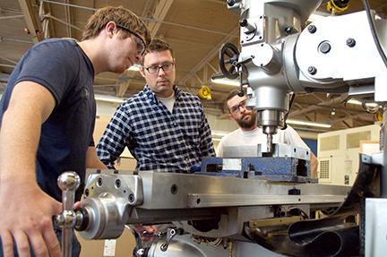 Machining instructor and students in the lab